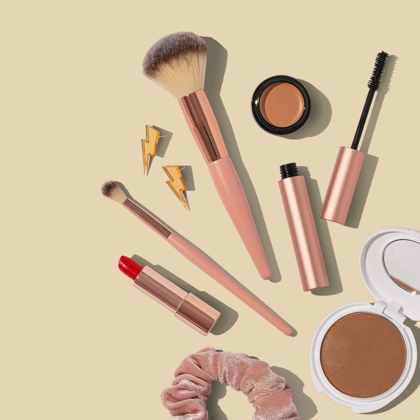 Everyday makeup brushes arranged beside cosmetics on a lived-in vanity